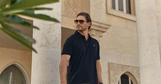 Man wearing a THEODORE polo shirt with signature crest detail, showcasing Smart Luxury menswear and refined warm-weather style.